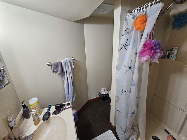 full bathroom with baseboards, a shower stall, and visible vents