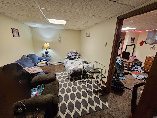 living room featuring carpet flooring and a drop ceiling