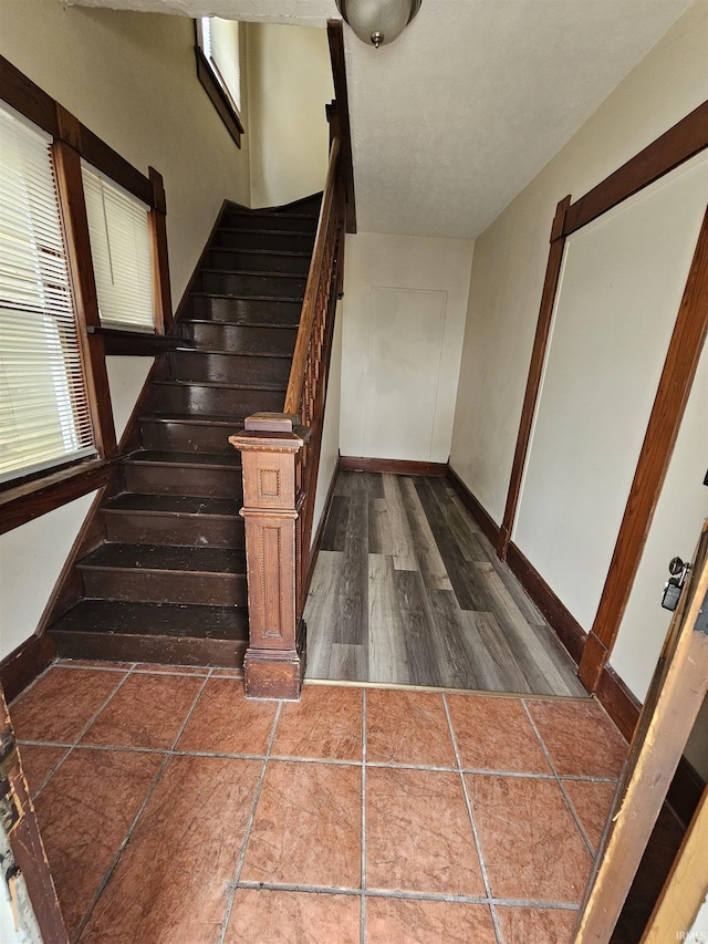 stairs with baseboards and wood finished floors