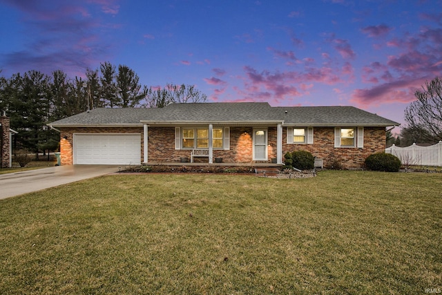 ranch-style home featuring brick siding, an attached garage, fence, a front yard, and driveway