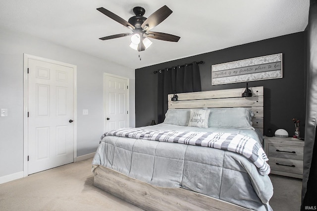 carpeted bedroom with a ceiling fan and baseboards