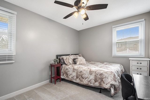 bedroom with light carpet, ceiling fan, and baseboards