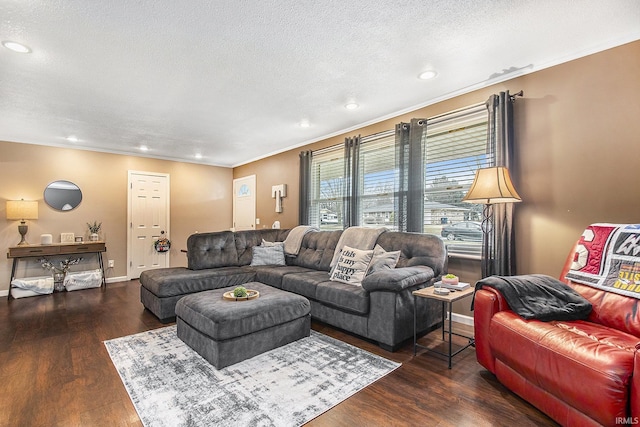 living area with dark wood-type flooring, a textured ceiling, recessed lighting, crown molding, and baseboards