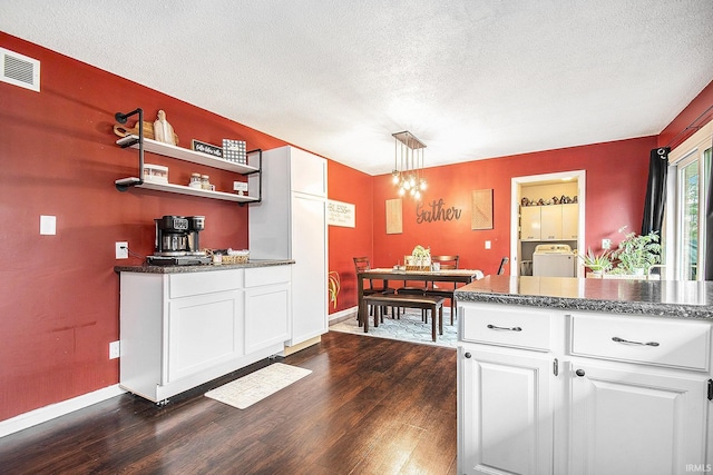 kitchen featuring visible vents, dark wood-type flooring, open shelves, a textured ceiling, and white cabinets