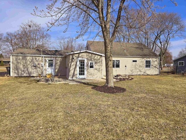 back of property featuring a patio and a lawn