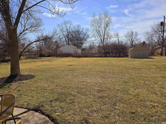 view of yard featuring an outbuilding and a storage unit