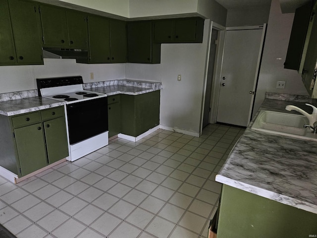 kitchen featuring electric range, under cabinet range hood, green cabinets, a sink, and light countertops