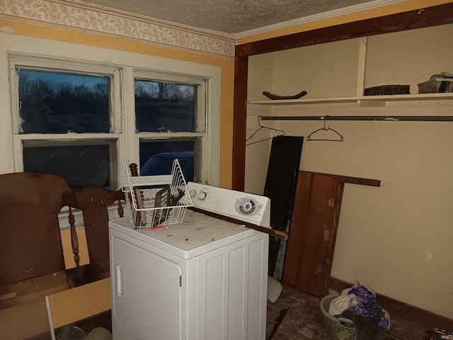 laundry area with washer / dryer, ornamental molding, laundry area, and a textured ceiling