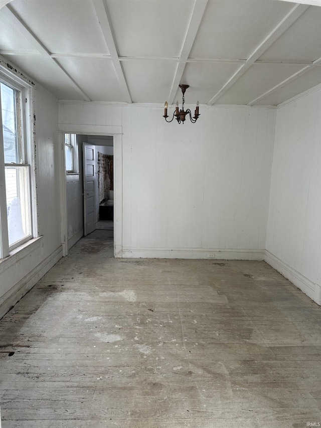 unfurnished dining area featuring a chandelier