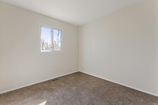 unfurnished room with visible vents, baseboards, and carpet