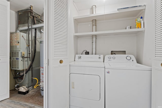 laundry area featuring gas water heater, laundry area, and washing machine and clothes dryer