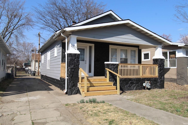 view of front facade with concrete driveway and covered porch