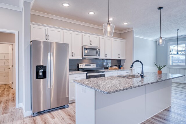 19138 Braeburn Dr, Evansville, IN 47725 - kitchen with a wainscoted wall, stainless steel appliances, light wood-style floors, white cabinetry, and a sink