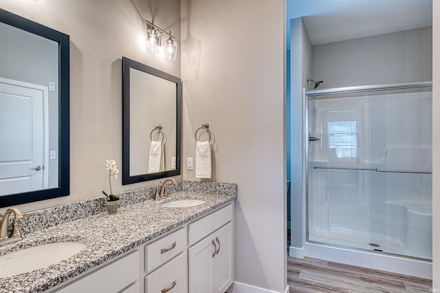 19138 Braeburn Dr, Evansville, IN 47725 - full bath featuring a shower stall, wood finished floors, double vanity, and a sink