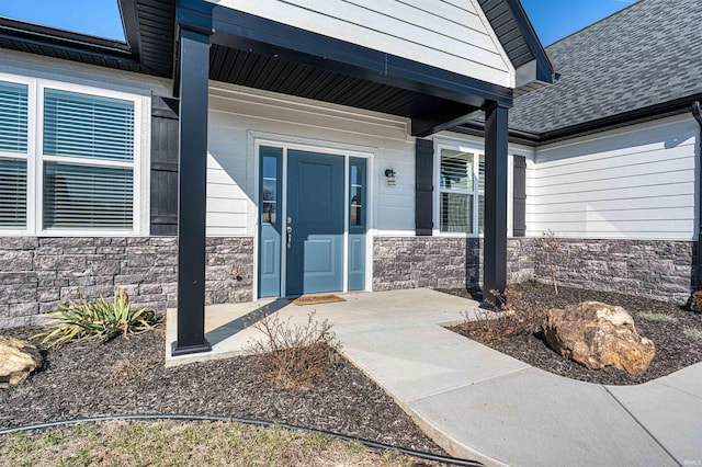 19138 Braeburn Dr, Evansville, IN 47725 - doorway to property featuring stone siding and a shingled roof