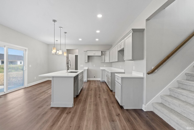 kitchen with dark wood finished floors, recessed lighting, baseboards, and a sink
