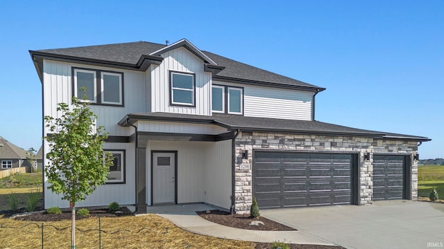 view of front of home featuring stone siding, driveway, a shingled roof, and an attached garage