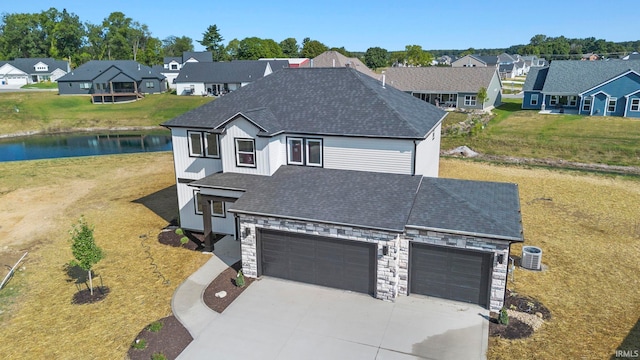 view of front of property with stone siding, a residential view, roof with shingles, and driveway