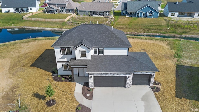 drone / aerial view featuring a residential view and a water view