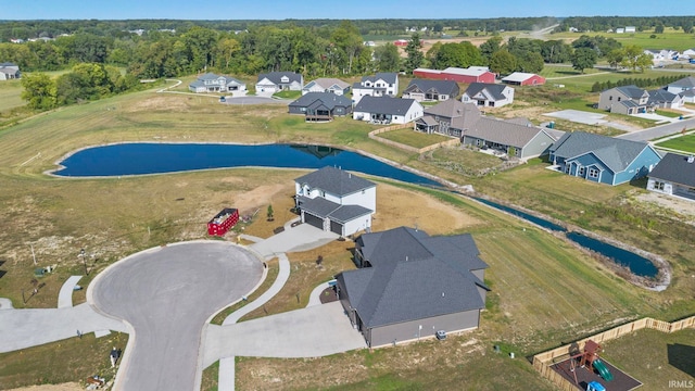 drone / aerial view featuring a residential view and a water view