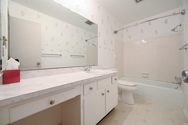 bathroom with tile patterned flooring, wallpapered walls, shower / washtub combination, toilet, and vanity