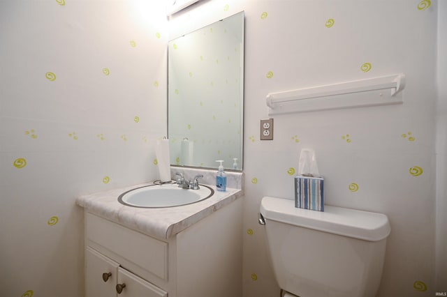 bathroom with toilet and vanity