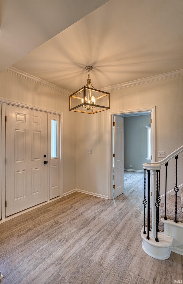 9700 Big Cynthiana Rd, Evansville, IN 47720 - entryway with a chandelier, ornamental molding, baseboards, and wood finished floors