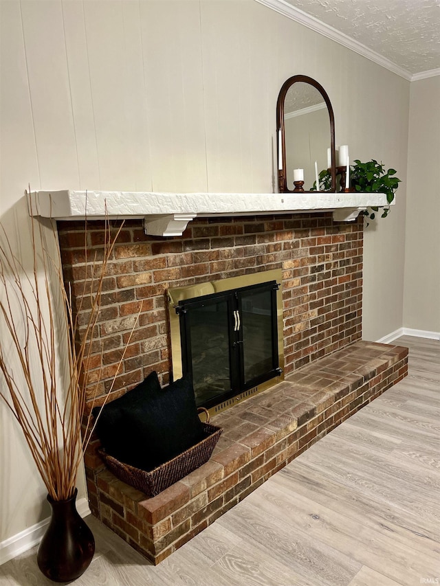 9700 Big Cynthiana Rd, Evansville, IN 47720 - interior details featuring a textured ceiling, wood finished floors, crown molding, baseboards, and a brick fireplace