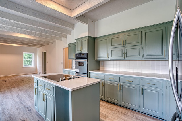 9700 Big Cynthiana Rd, Evansville, IN 47720 - kitchen with tasteful backsplash, a center island, light countertops, appliances with stainless steel finishes, and light wood-style floors