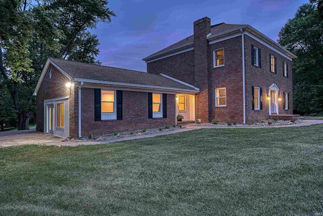 9700 Big Cynthiana Rd, Evansville, IN 47720 - view of front of house with a front yard, brick siding, and a chimney