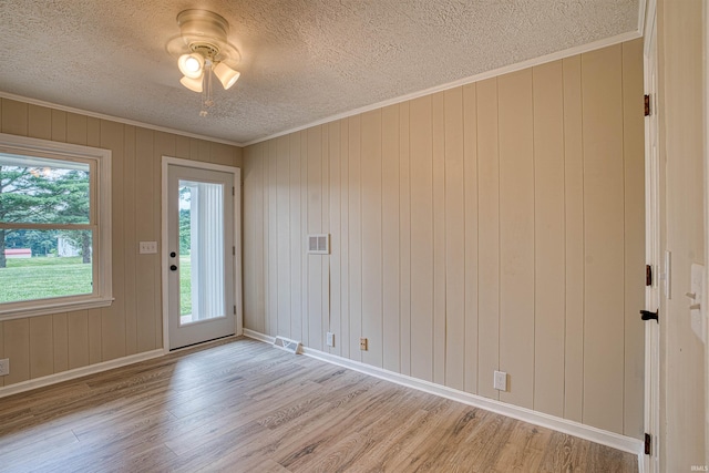 9700 Big Cynthiana Rd, Evansville, IN 47720 - empty room featuring light wood finished floors, visible vents, crown molding, ceiling fan, and a textured ceiling