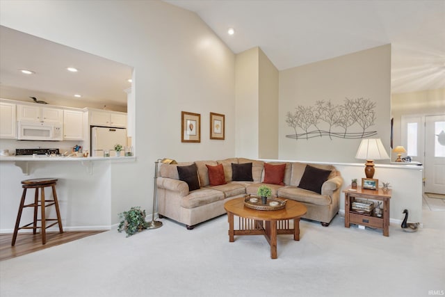 living room with light carpet, recessed lighting, baseboards, and lofted ceiling