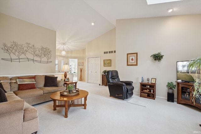 living area featuring visible vents, high vaulted ceiling, baseboards, and carpet floors