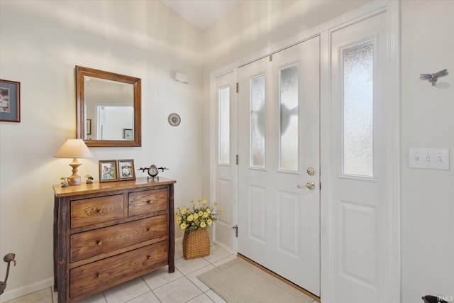 entryway featuring light tile patterned floors and baseboards