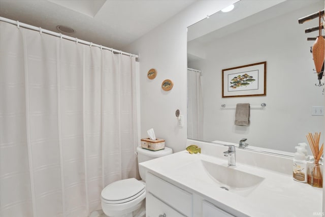 bathroom featuring vanity, toilet, and a shower with curtain