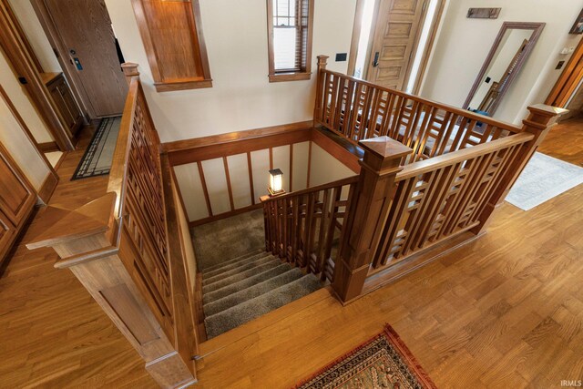 stairs featuring wood finished floors