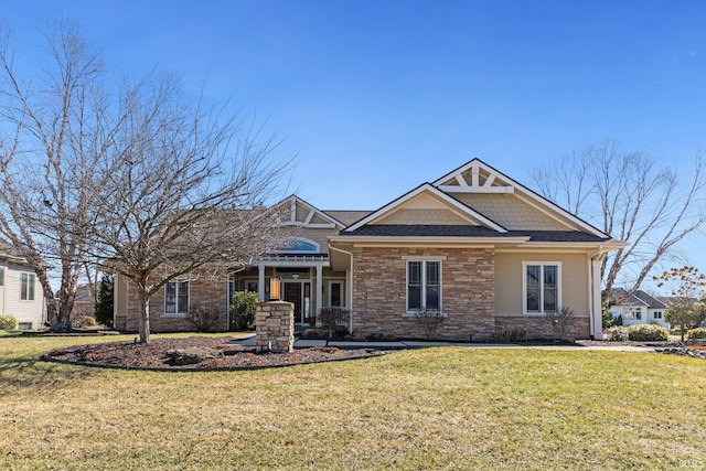 craftsman-style house featuring a front lawn and stone siding