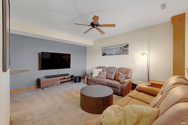 carpeted living area with visible vents, baseboards, and ceiling fan