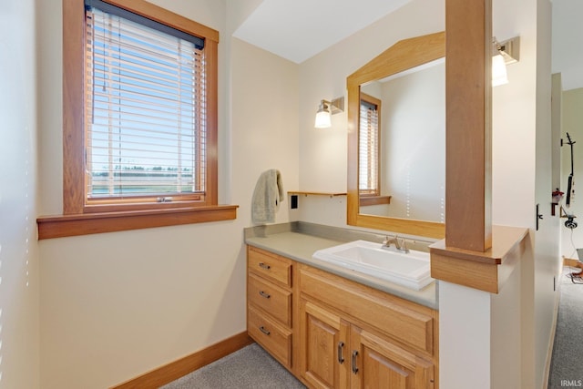 bathroom featuring baseboards and vanity