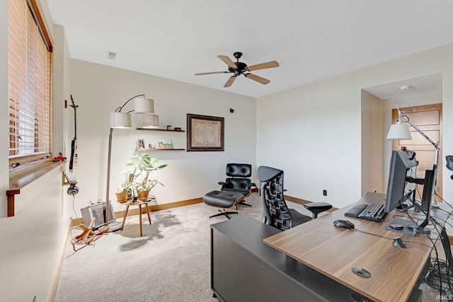 carpeted office with visible vents, baseboards, and ceiling fan