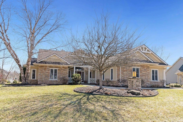 view of front of house with a front yard and stone siding