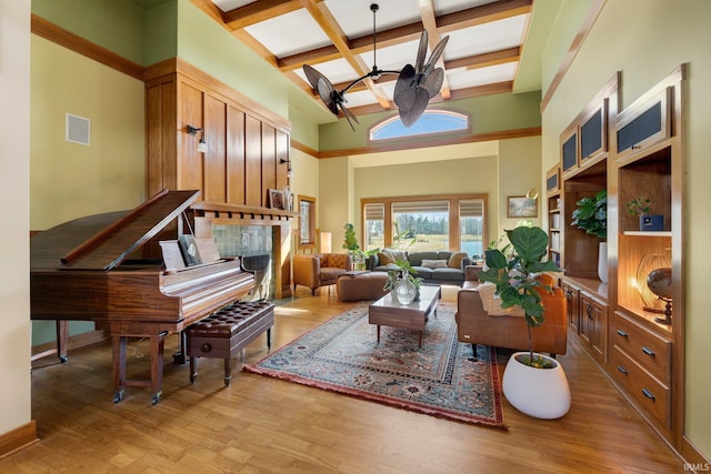 living area with visible vents, beamed ceiling, light wood-type flooring, an inviting chandelier, and coffered ceiling