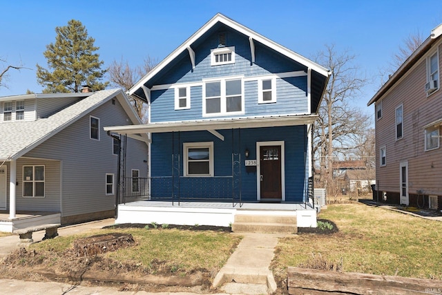 view of front of house with covered porch and a front yard