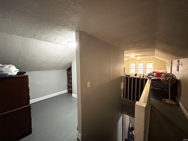 1428 11th St, Tell City, IN 47586 - hallway with a textured ceiling, baseboards, and vaulted ceiling