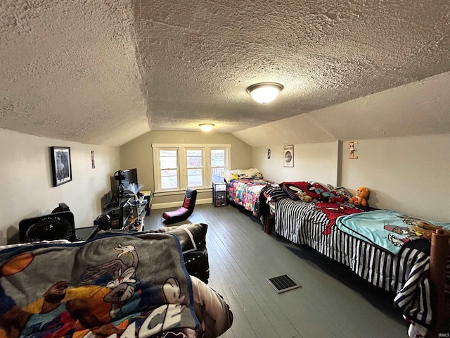 1428 11th St, Tell City, IN 47586 - bedroom featuring a textured ceiling, vaulted ceiling, and hardwood / wood-style flooring