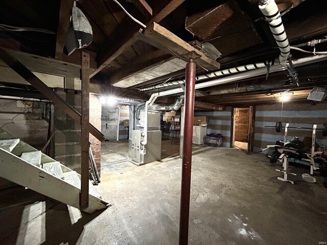 1428 11th St, Tell City, IN 47586 - unfinished below grade area with heating unit and washer / clothes dryer