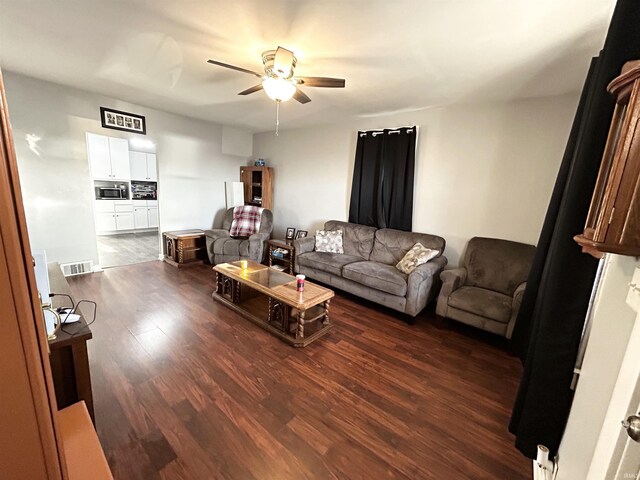 1428 11th St, Tell City, IN 47586 - living area with dark wood finished floors, a ceiling fan, and visible vents