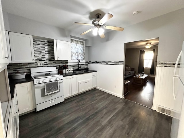 1428 11th St, Tell City, IN 47586 - kitchen featuring a sink, a ceiling fan, dark wood-style flooring, and white gas range oven