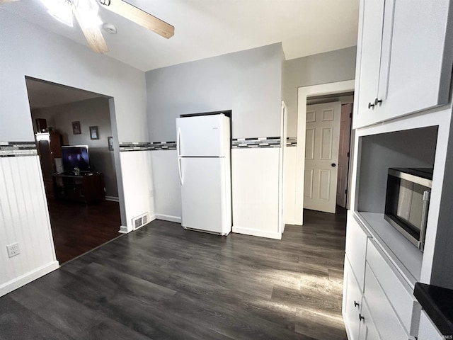 1428 11th St, Tell City, IN 47586 - kitchen featuring visible vents, stainless steel microwave, freestanding refrigerator, white cabinets, and ceiling fan