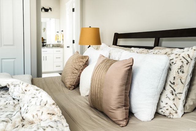bedroom featuring ensuite bath and bar area